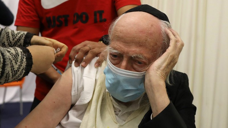 A health care worker vaccinates an elderly man against COVID-19 in Jerusalem Dec. 21, 2020. The Vatican's doctrinal office said it is morally acceptable to receive COVID-19 vaccines using cell lines originating from aborted fetuses when alternative vaccines are not made available. (CNS photo/Ammar Awad, Reuters)