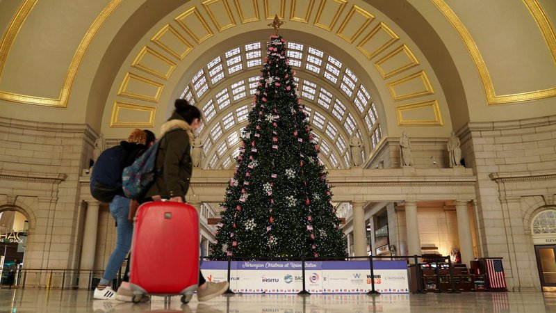 Passengers in Washington walk by a Christmas tree at Union Station Dec. 23, 2020. (CNS photo/Kevin Lamarque, Reuters)