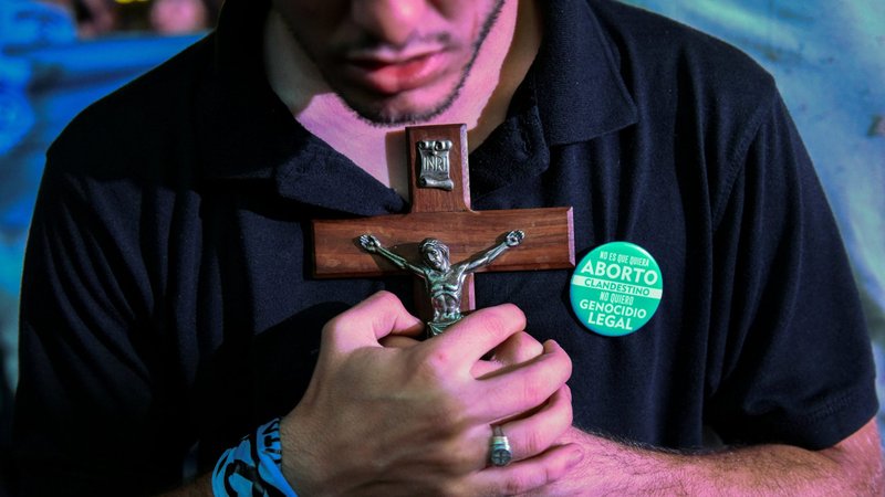 A pro-life demonstrator holds a crucifix after the Senate passed an abortion bill in Buenos Aires, Argentina, Dec. 30, 2020. Abortion will be legal during the first 14 weeks of pregnancy. (CNS photo/Martin Villar, Reuters)
