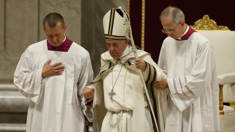 Pope Francis is assisted by aides as he leaves a prayer vigil in St. Peter's Basilica at the Vatican Oct. 1, 2019. Recurring bouts of sciatica, a painful back ailment, often mean the pope needs assistance walking up and down steps. (CNS photo/Paul Haring)