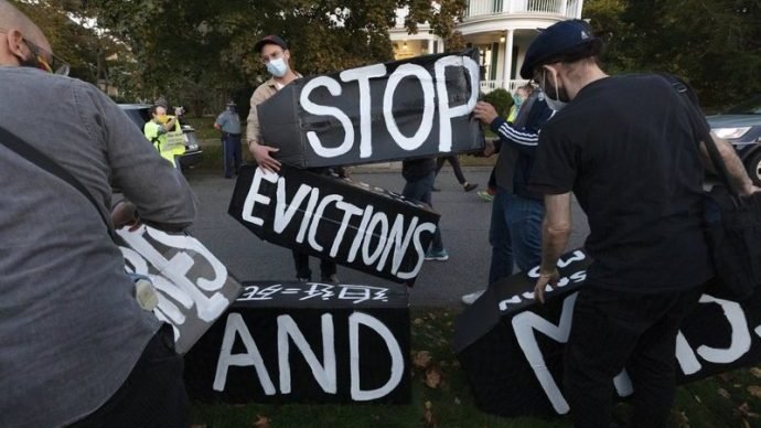 Housing activists erect a sign in front of Massachusetts Gov. Charlie Baker's house, Wednesday, Oct. 14, 2020, in Swampscott, Mass. (Michael Dwyer/AP via Crux)