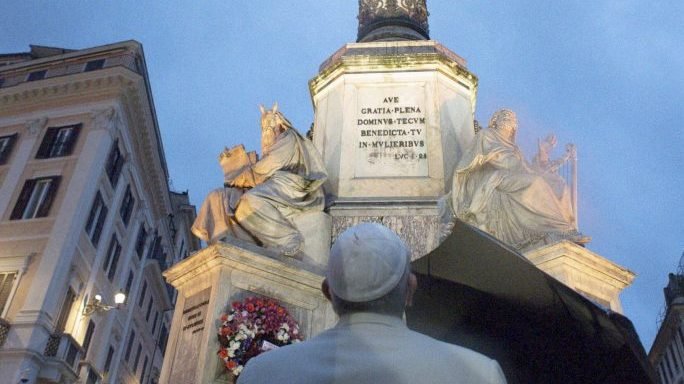 Pope Francis prays beneath the statue of the Virgin Mary on the occasion of Immaculate Conception day, at the Spanish Steps, in Rome, Tuesday, Dec. 8, 2020. Pope Francis paid a surprise visit to the statue early Tuesday after last week the Vatican announced that due to the COVID-19 pandemic his annual pilgrimage to the statue in the center of Rome would be cancelled to avoid contagion due to gatherings. (Vatican News/AP via Crux)
