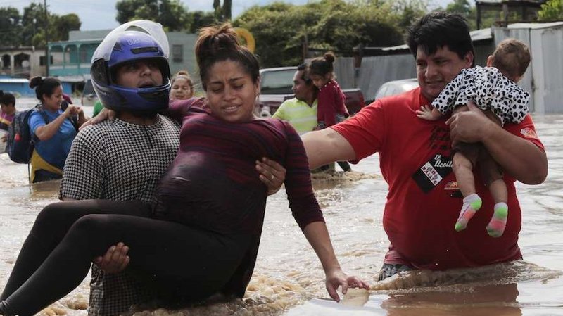 A pregnant woman is carried out of an area flooded by Hurricane Eta in Planeta, Honduras, Nov. 5, 2020. (Alex Gakos/Shutterstock via CNA)