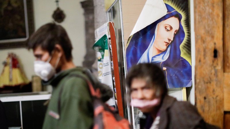 An image of Mary is pictured as homeless people celebrate New Year's Eve dinner at Our Lady of Solitude Catholic Church in Mexico City during the COVID-19 pandemic. The church becomes a shelter for the homeless in the winter. (CNS photo/Gustavo Graf, Reuters)