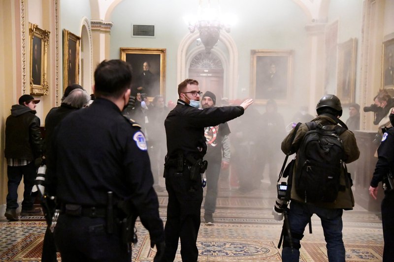 A security officer gestures after supporters of President Donald Trump breached security defenses at the U.S. Capitol building in Washington Jan. 6, 2021. (CNS photo/Mike Theiler, Reuters)