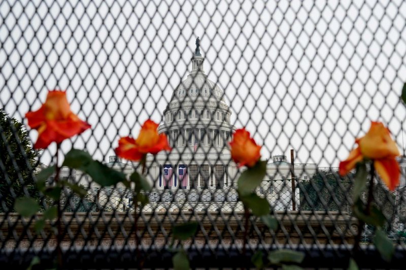 Flowers are placed in security fencing around the U.S. Capitol in Washington Jan. 11, 2021, days after supporters President Donald Trump stormed the the building. (CNS photo/Erin Scott, Reuters)