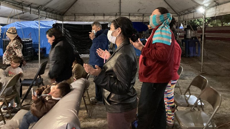 Asylum-seekers pray during Mass at a tent camp along the Rio Grande in Matamoros, Mexico, Jan. 9, 2021. The asylum-seekers are in a program where they must remain in Mexico while their cases are heard in U.S. courts. The election of Joe Biden has sparked some optimism their plight may be resolved soon, according to activists working with them. (CNS photo/David Agren)