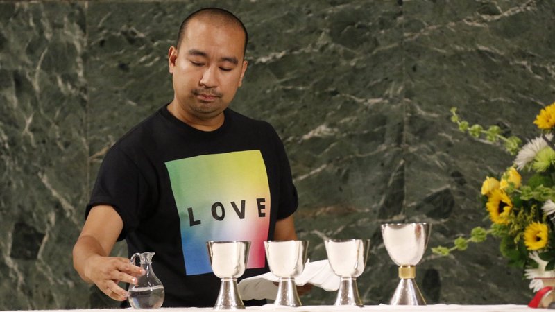 Altar server Angelo Alcasabas prepares the altar during an annual "Pre-Pride Festive Mass" at St. Francis of Assisi Church in New York City June 29, 2019. (CNS photo/Gregory A. Shemitz)