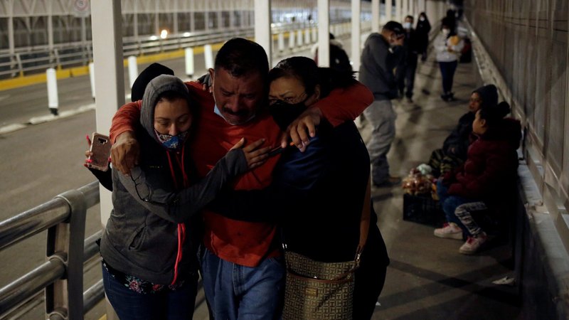 Felipe Ortega of Mexico meets his family at the Paso del Norte border crossing bridge in Ciudad Juarez after being deported from the U.S. Jan. 20, 2021. (CNS photo/Jose Luis Gonzalez, Reuters)