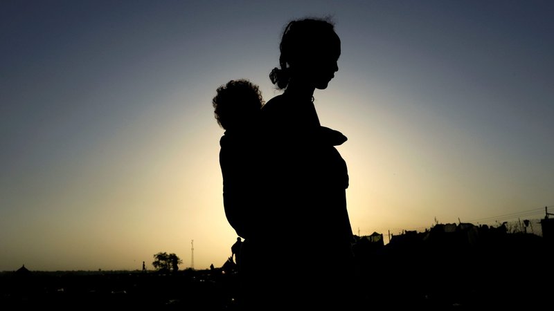 An Ethiopian woman who fled the ongoing fighting in the Tigray region carries her child near the Sudan-Ethiopia border in Sudan's Kassala state Nov. 22, 2020. Pope Francis' prayer intention for February is for women who are victims of violence. (CNS photo/Mohamed Nureldin Abdallah, Reuters)