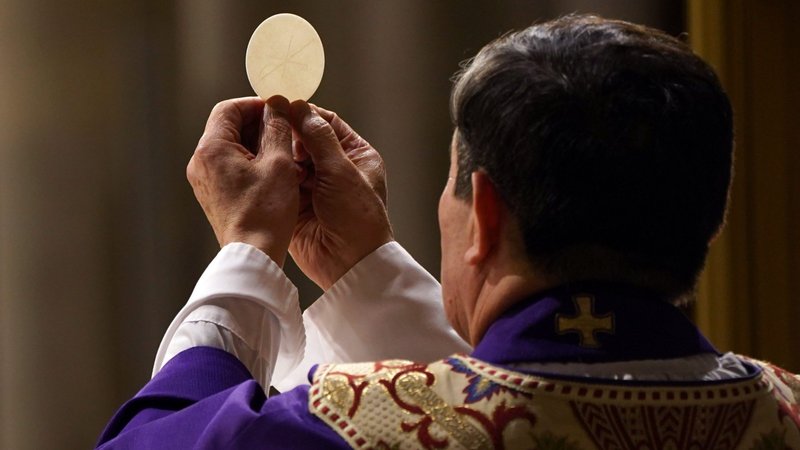A priest elevates the host during a Mass at St. Patrick's Cathedral in New York City in 2020. (CNS photo/Gregory A. Shemitz)