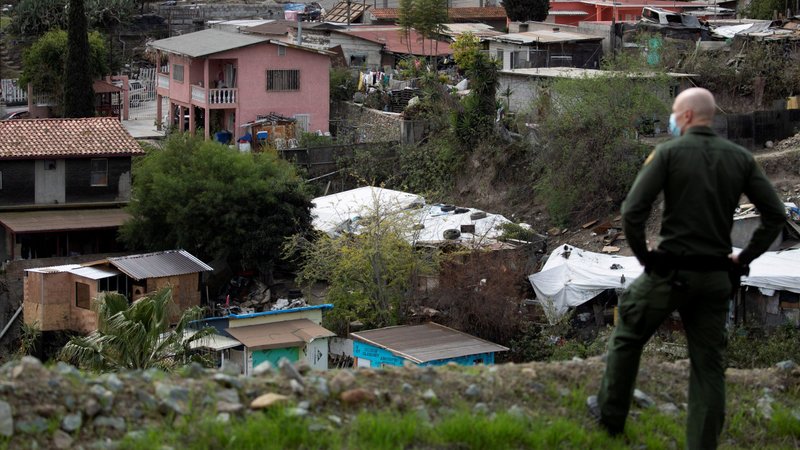A U.S. Border Patrol agent in San Diego looks into Tijuana, Mexico, Feb. 2, 2021. (CNS photo/Mike Blake, Reuters)