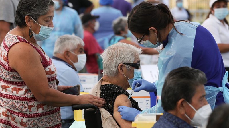 A health care worker administers a dose of the Sinovac's CoronaVac COVID-19 vaccine to a person at a vaccination center in Santiago, Chile, Feb. 3, 2021. (CNS photo/Ivan Alvarado, Reuters)