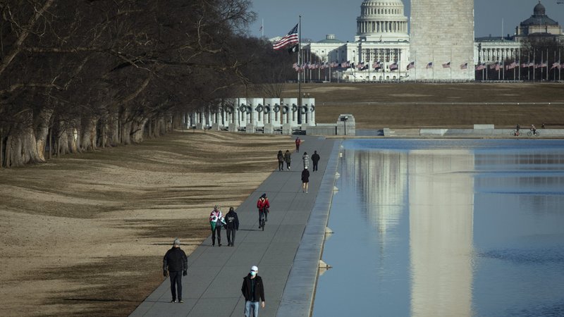 People walk along the National Mall and the U.S. Capitol in Washington Feb. 8, 2021. (CNS photo/Tyler Orsburn)
