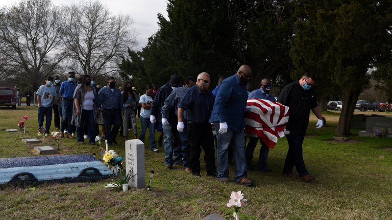 Pallbearers in San Felipe, Texas, carry the casket of Gregory Blanks, 50, Jan. 26, 2021, who died of the coronavirus disease. (CNS photo/Callaghan O'Hare, Reuters)