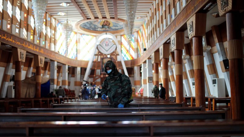 A member of the civil defense team disinfects inside Our Lady of Salvation Church in Baghdad, Iraq, Dec. 30, 2020, during the COVID-19 pandemic. Iraq is set to receive thousands of Pfizer-BioNTech COVID-19 vaccines in addition to the Chinese Sinovac vaccine this month. Pope Francis plans to visit Iraq March 5-8. (CNS photo/Thaier Al-Sudani, Reuters)