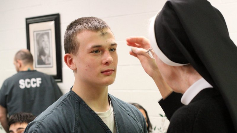 An inmate receives ashes from a nun on Ash Wednesday at the Suffolk County Correctional Facility in Riverhead, N.Y. in this Feb. 18, 2015, file photo. Just as farmers sprinkle ashes on fields to give soil nutrients, ashes on Ash Wednesday are reminder to return to the essential, be renewed and be fruitful, said Servite Father Ermes Ronchi, who lead Pope Francis' Lenten retreat in 2016. (CNS photo/Gregory A. Shemitz)