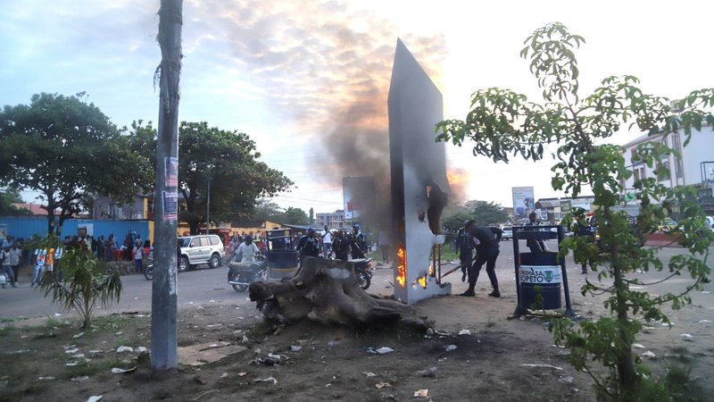 A first responder attempts to put out a fire in Kinshasa, Congo, Feb. 17, 2021. A bishop in eastern Congo is urging Catholics to step up humanitarian gestures during Lent, after rebel forces stormed a church in Ituri province during Mass Feb. 14, killing and injuring dozens. (CNS photo/Kenny Katombe, Reuters)