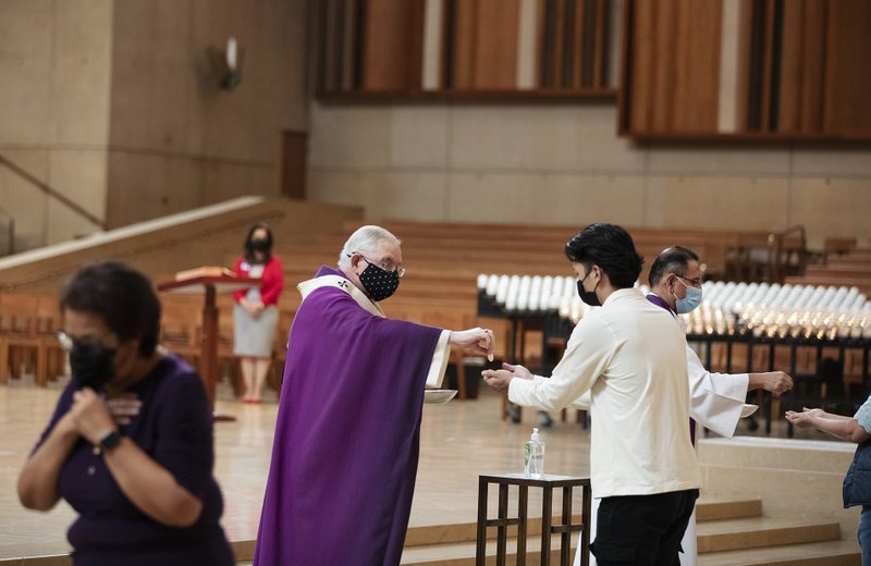 Archbishop Gomez distributes communion during Ash Wednesday Mass at the Cathedral Feb. 17. (Victor Alemán)