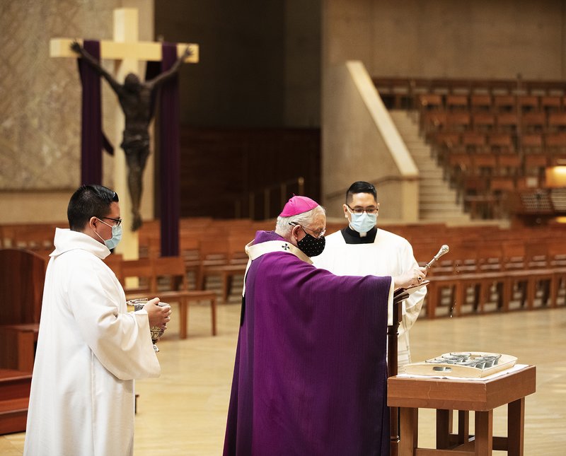 Archbishop Gomez blesses the ashes Feb. 17 at Mass at the Cathedral of Our Lady of the Angels for Ash Wednesday. Archbishop Gomez distributes ashes at the Feb. 17 Mass at the Cathedral. (Victor Alemán)