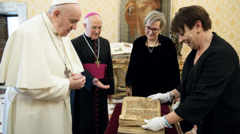 Pope Francis is presented with an Aramaic prayer manuscript at the Vatican Feb. 10, 2021. (Vatican Media/Ufficio Stampa FOCSIV via CNA)