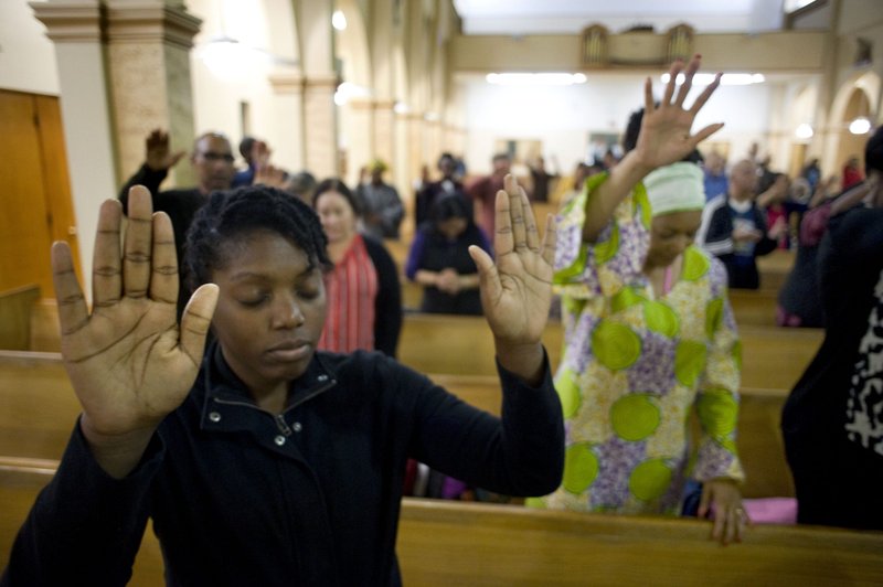 A young woman prays on the second evening of an African American Catholic revival celebration at St. Rita's Church in San Diego in 2018. (Catholic News Service file photo/David Maung)