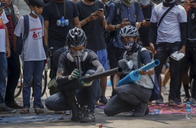 Anti-coup protesters test improvised weapons made to fight with government security forces in Yangon, Myanmar, Wednesday, March 17, 2021. (AP Photo via Crux)