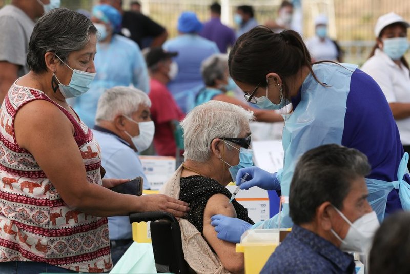 A health care worker administers a dose of the Sinovac's CoronaVac COVID-19 vaccine to a person at a vaccination center in Santiago, Chile, Feb. 3, 2021. (Ivan Alvarado/Reuters via CNS)