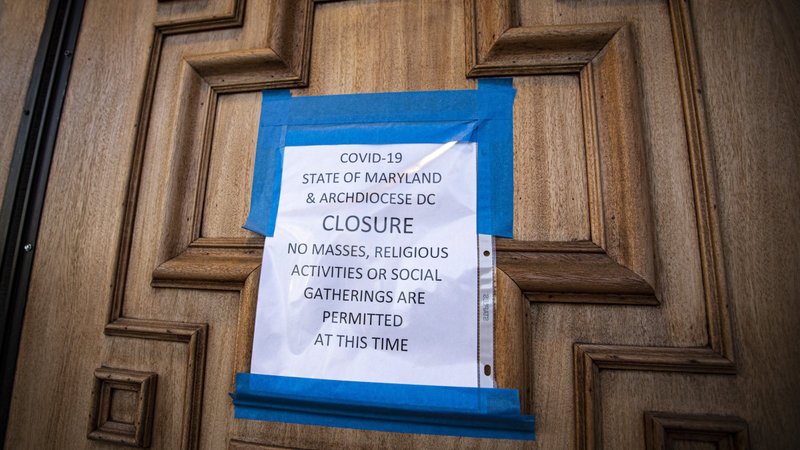 A sign on the door of St. Mary's Catholic Church in Landover Hills, Md., alerts the public there will be no Sunday Mass March 22, 2020. The U.S. Conference of Catholic Bishops' Administrative Committee released a pastoral message March 9, 2021, marking one year since the coronavirus pandemic "changed life" and "ushered in suffering" in the United States. (CNS photo/Chaz Muth)
