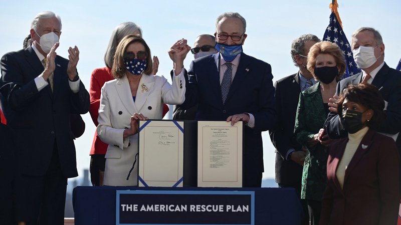 House Speaker Nancy Pelosi, D-Calif., and Senate Majority Leader Chuck Schumer, D-N.Y., display the "American Rescue Plan" during the enrollment ceremony on Capitol Hill in Washington March 10, 2021, following passage of President Joe Biden's $1.9 trillion coronavirus disease relief bill. (CNS photo/Erin Scott, Reuters)