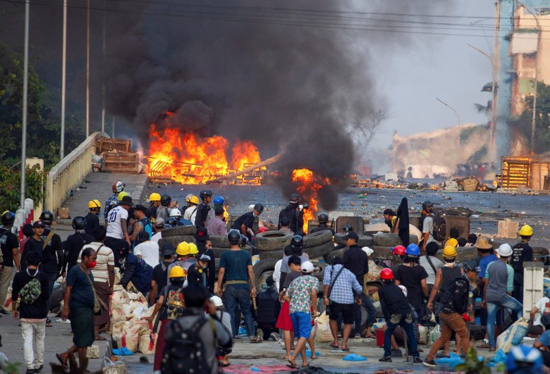 Anti-coup protesters stand at a barricade as they clash with security forces on Bayint Naung Bridge in Yangon, Myanmar, March 16, 2021. (CNS photo/Reuters)