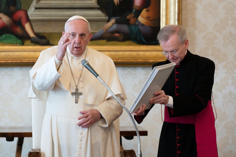 Pope Francis delivers his blessing as he leads his general audience in the library of the Apostolic Palace at the Vatican March 17, 2021. The pope spoke about the role of the Holy Spirit in making Jesus present in people's lives. (CNS photo/Vatican Media)