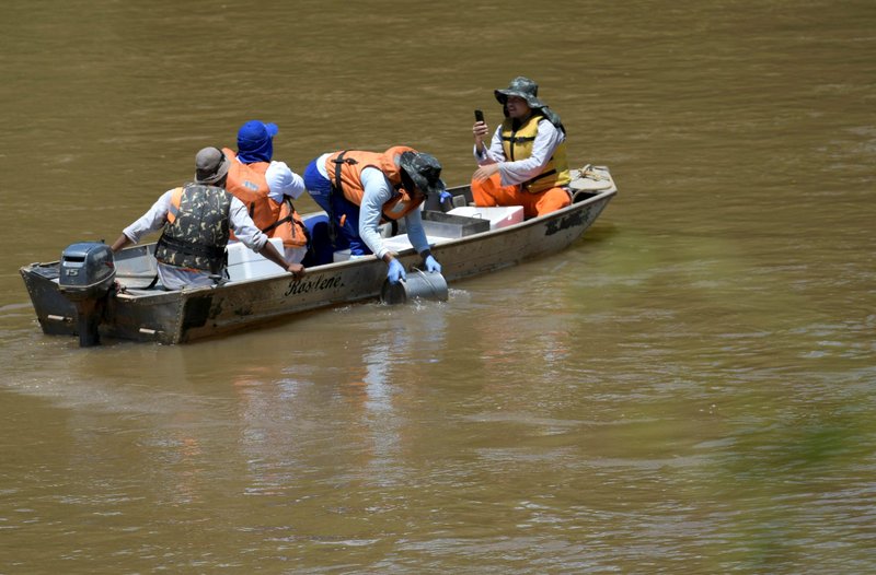 Employees of the Vale S.A. company monitor the water quality on the Paraopeba River after a dam owned by the Brazilian mining company collapsed, in Para de Minas near Brumadinho, Brazil, in this Feb. 2, 2019, file photo. The Vatican's Dicastery for Promoting Integral Human Development said more investment and action are needed to ensure people have access to clean and safe water for drinking and sanitation. (CNS photo/Washington Alves, Reuters)