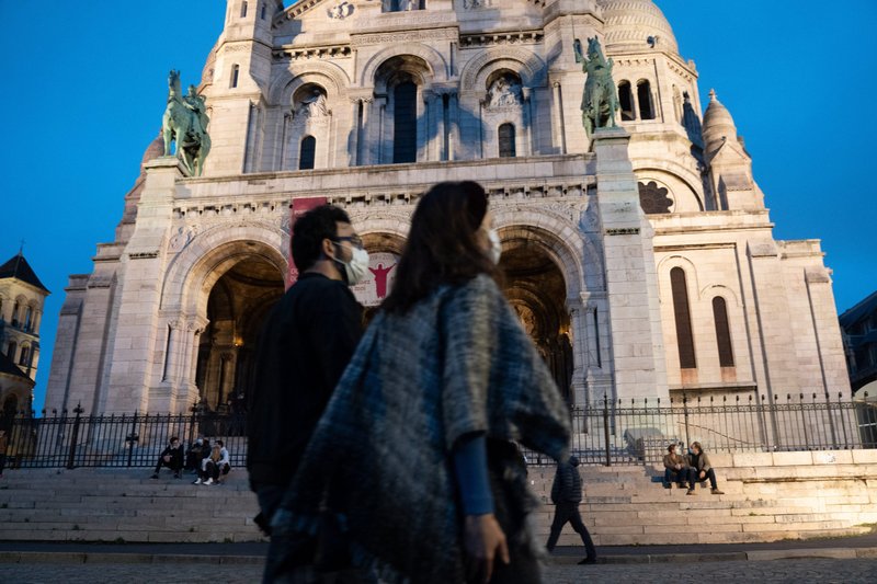 People wearing protective masks walk past the closed Basilica of the Sacred Heart in Paris Nov. 1, 2020, during the COVID-19 pandemic. Catholic bishops say Christians in Europe are not being persecuted, but some governments have diminished religious freedom during the pandemic. (CNS photo/Laure Playoust/Hans Lucas, Reuters)