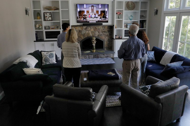The Lando family of Carlisle, Mass., participate in St. Mary's Catholic Church livestreamed Easter Mass April 12, 2020, during the coronavirus pandemic. (CNS photo/Brian Snyder, Reuters)
