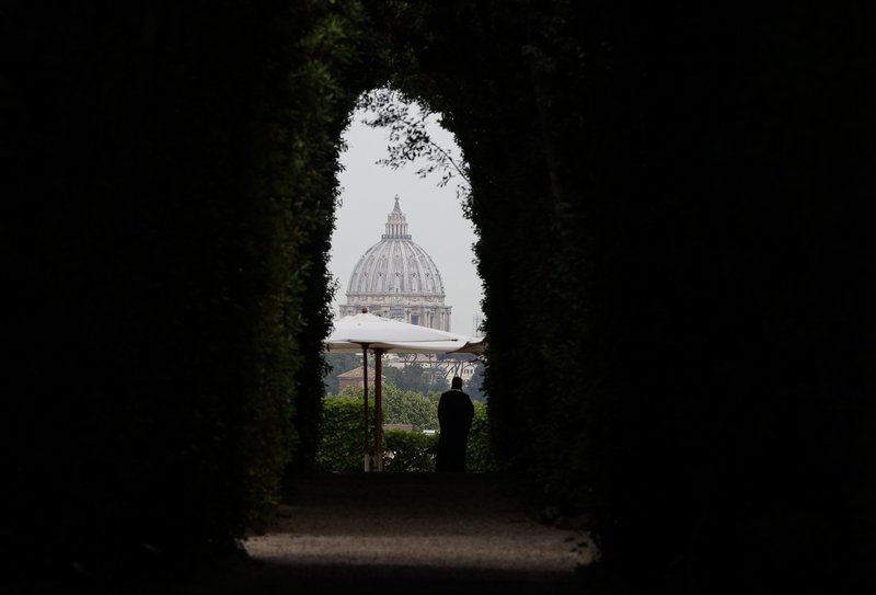 The dome of St. Peter's Basilica at the Vatican is seen from the Aventine Hill in Rome in this May 2, 2018, file photo. Pope Francis has approved pay cuts for cardinals, top managers and religious personnel working at the Vatican. (CNS photo/Paul Haring)