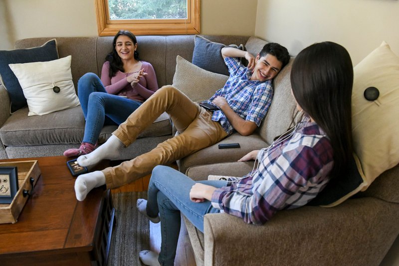 Marco Pantoja III, 18, center, hangs out with his sisters Sofia, 16, left, and Elena, 13, March 7, 2021, at their home in Valatie, N.Y. Marco will sponsor his family when they are baptized as Catholics April 3, the Easter Vigil. (CNS photo/Cindy Schultz via The Evangelist)