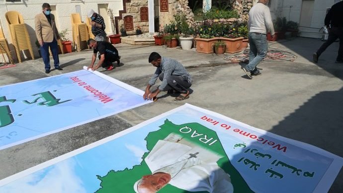Iraq Christians prepare posters welcoming Pope Francis to St. Joseph's Chaldean Church ahead of the Pope's visit, in Baghdad, Iraq, Tuesday, March 2, 2021. (Khalid Mohammed/AP via Crux)