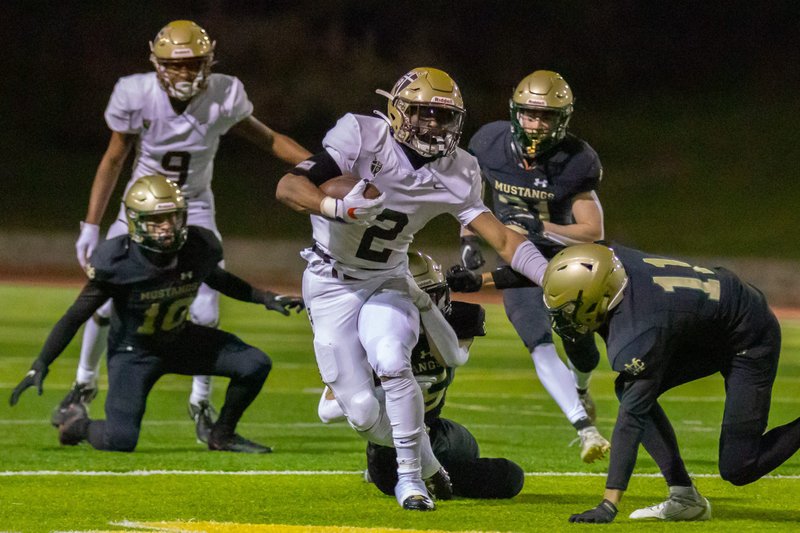 St. Francis' junior running back Max Garrison (2) tears through Mira Costa defenders in the Golden Knights' 38-35 victory March 13, the season opener delayed by more than six months. (St. Francis High School)