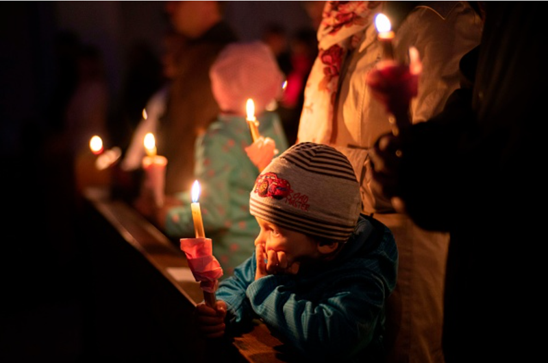 People light candles at the Catholic church of Saint Mary of Snows in Bratislava, Slovakia, at the 2019 Easter Vigil. (Joe Klamar/AFP via Getty Images)