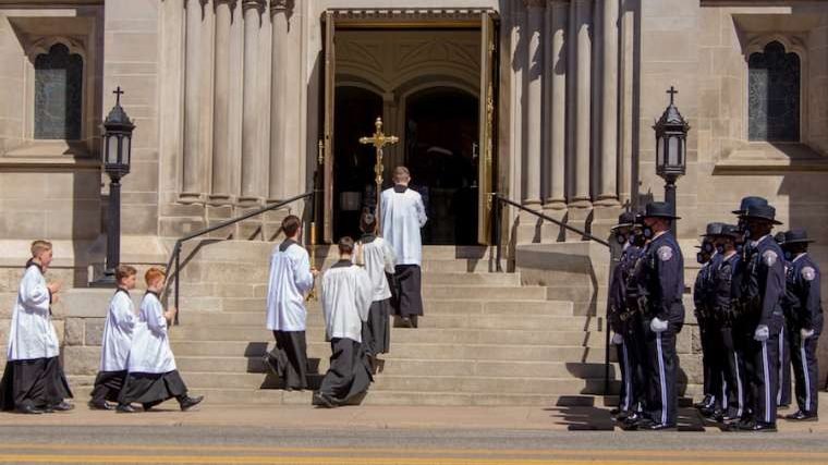 Police officers watch as altar servers enter the Cathedral Basilica of the Immaculate Conception in Denver for the funeral of police officer Eric Talley. (Ted Mast via CNA)