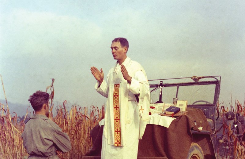 U.S. Army chaplain Father Emil Joseph Kapaun, who died May 23, 1951, in a North Korean prisoner of war camp, is pictured celebrating Mass from the hood of a jeep Oct. 7, 1950, in South Korea. He is a candidate for sainthood. (CNS photo/courtesy U.S. Army medic Raymond Skeehan)