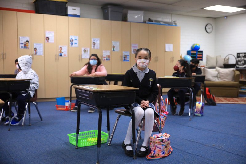 St. Bernard students sit at spaced-out desks in the third grade classroom. (David Amador Rivera)