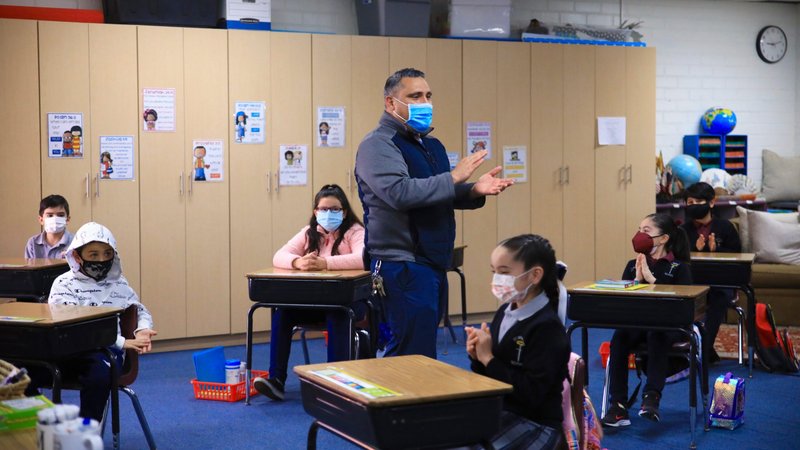 Principal Aaron De Loera talks to 3rd grade students on the first day of in-person class at St. Bernard Catholic School in Bellflower on March 3, 2021. (David Amador Rivera)