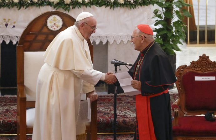Pope Francis is welcomed by the Chaldean patriarch, Cardinal Luis Sako, at the Sayidat al-Nejat (Our Lady of Salvation) Cathedral, in Baghdad, Iraq, Friday, March 5, 2021. (Andrew Medichini/AP via Crux)