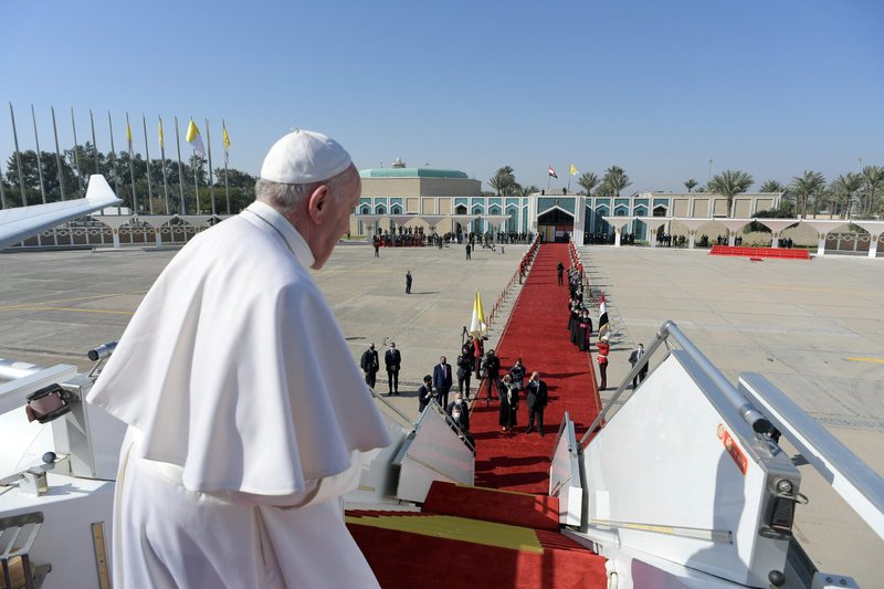 Pope Francis looks back from the stairs of the papal plane at Baghdad International Airport March 8, 2021, before departing on his flight to Rome. (CNS photo/Vatican Media via Reuters)