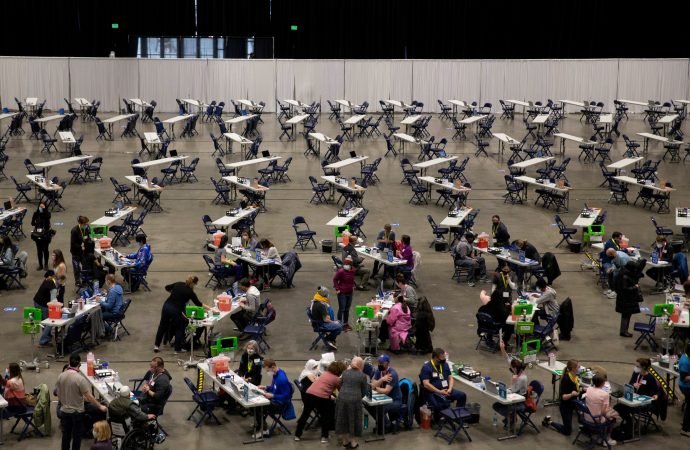 People receive COVID-19 vaccines at Lumen Field Event Center in Seattle March 13, 2021. (Lindsey Wasson/Reuters via CNS)
