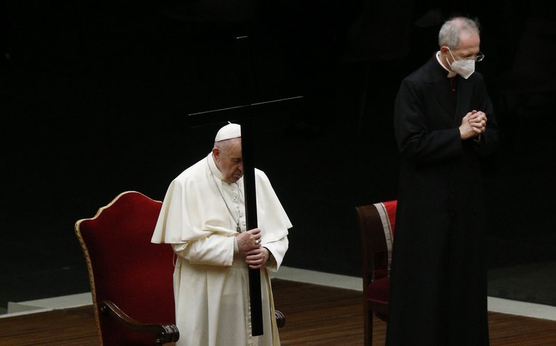 Pope Francis holds the cross as he leads the Way of the Cross in St. Peter's Square at the Vatican April 2, 2021. (CNS photo/Paul Haring)