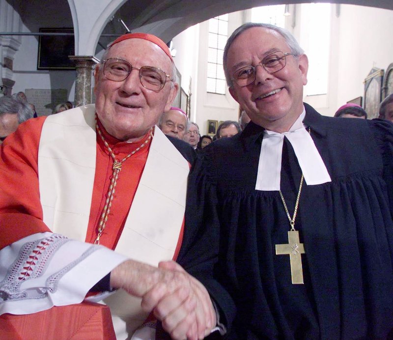 Australian Cardinal Edward I. Cassidy died April 10 at the age of 96. He is pictured with German Lutheran Bishop Christian Krause at the signing of "The Joint Declaration on the Doctrine of Justification'' in Augsburg, Germany, Oct. 31, 1999. Cardinal Cassidy, representing the Vatican, and Bishop Krause, president of the Lutheran World Federation, signed the document marking the resolution of a doctrinal dispute that sparked the Reformation. (CNS photo/Ralph Orlowski, Reuters)