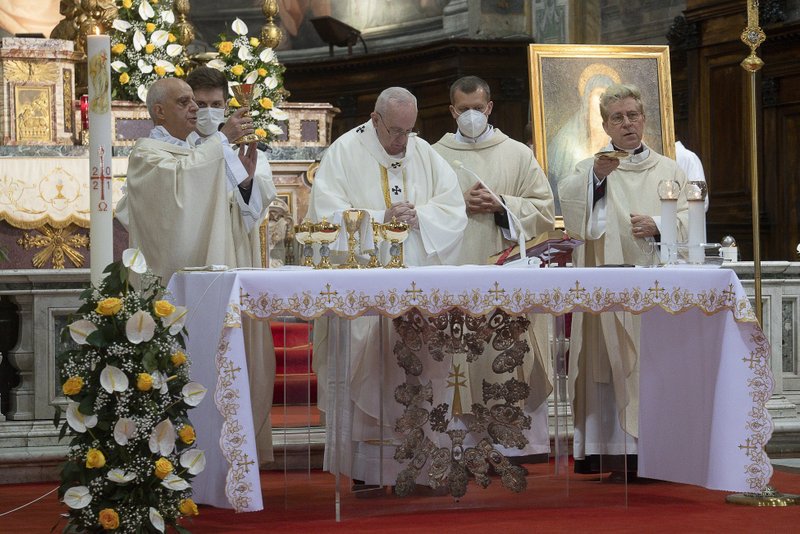 Pope Francis celebrates Mass for Divine Mercy Sunday at the Church of the Holy Spirit near the Vatican in Rome April 11, 2021. Concelebrating with the pope are Archbishop Rino Fisichella, president of the Pontifical Council for Promoting New Evangelization, left, and Msgr. Jozef Bart, right, rector of the church. (CNS photo/Vatican Media)